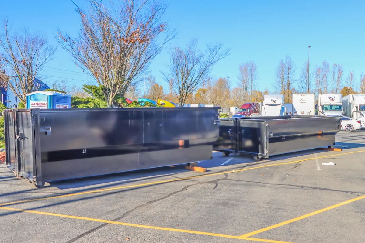 Professional dumpster rental service with roll-off container on residential driveway in Blooming Grove